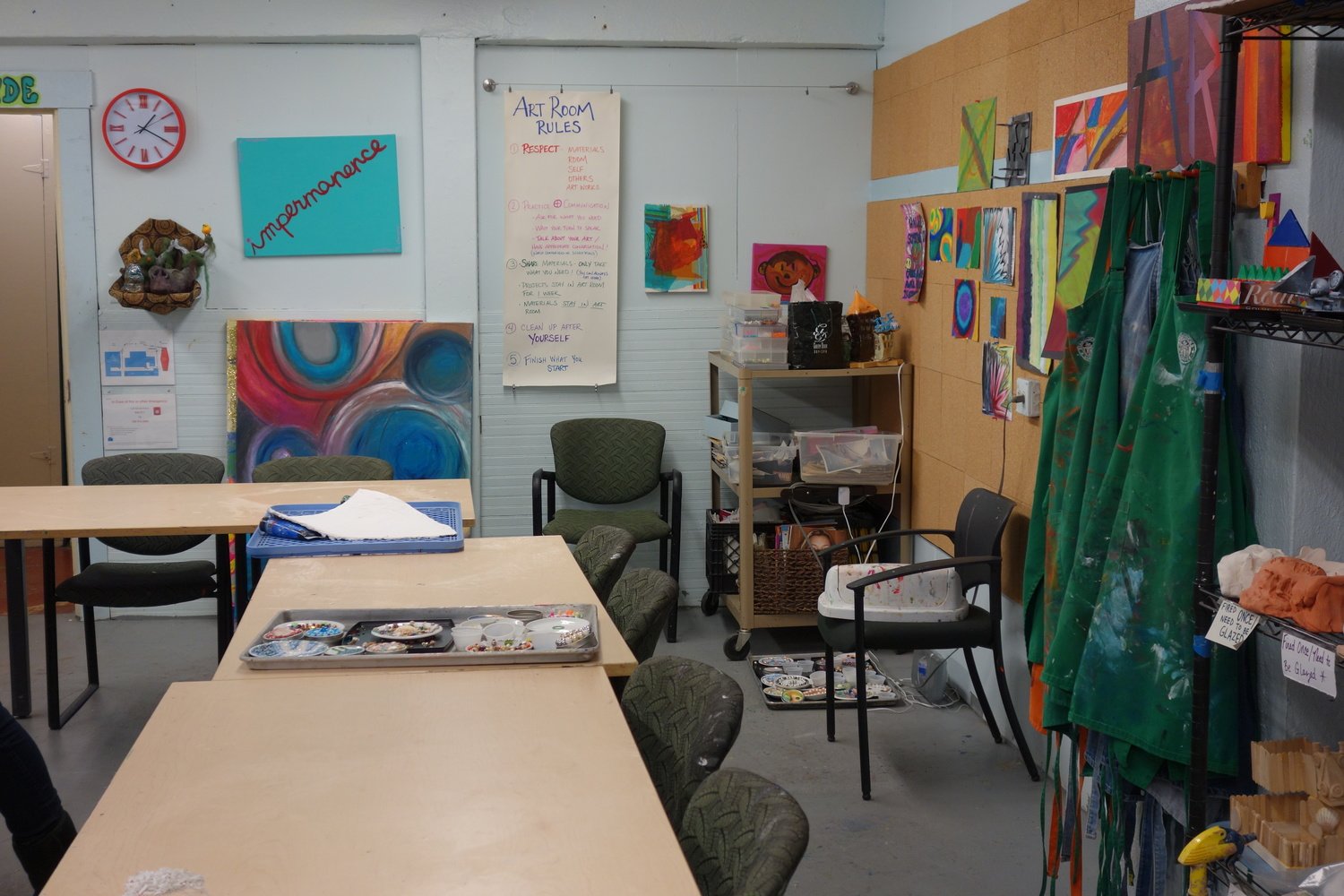 Kids explore through clay, paint, found objects, charcoal and oil sticks.